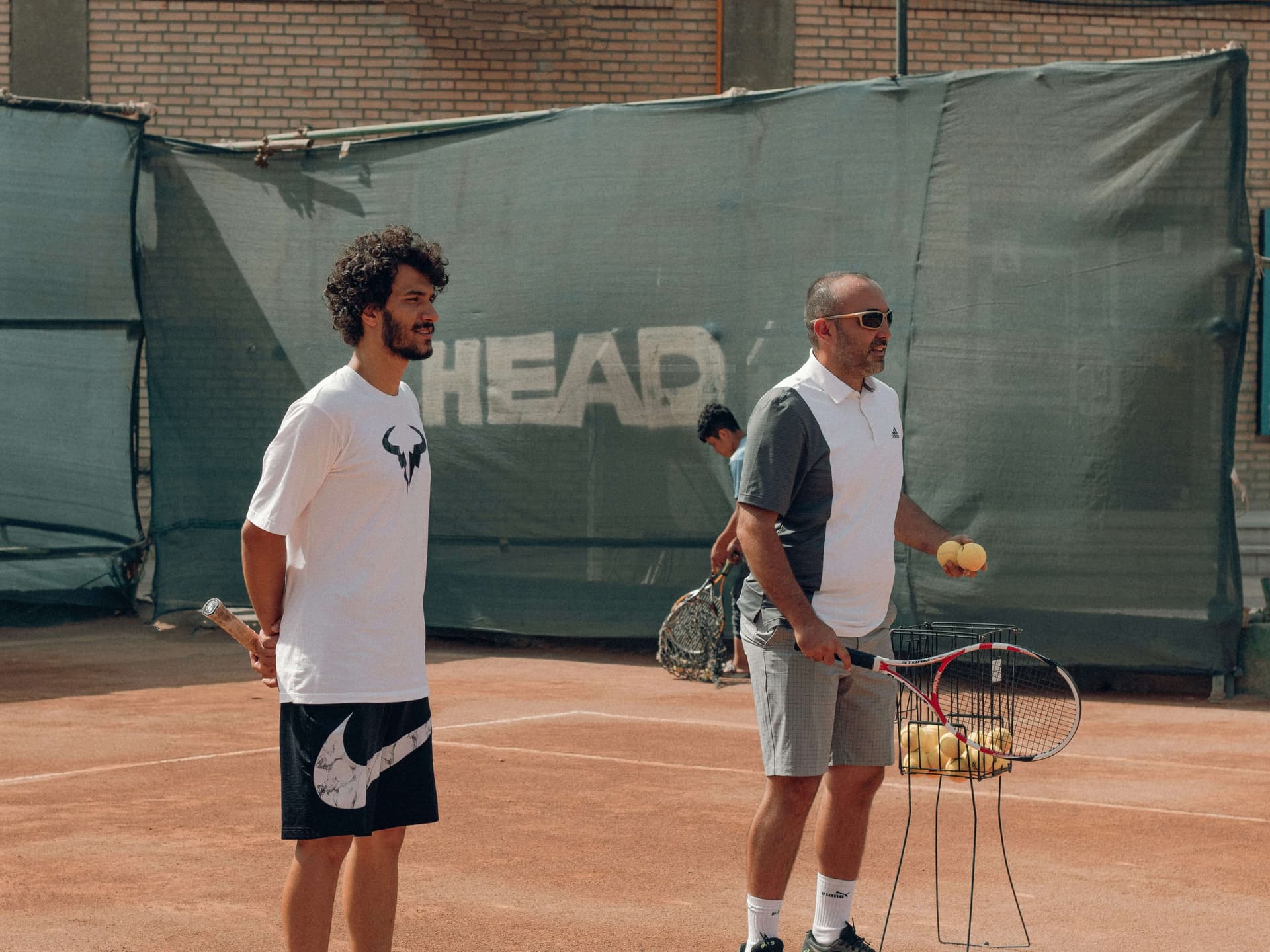 Tennis coach giving lesson